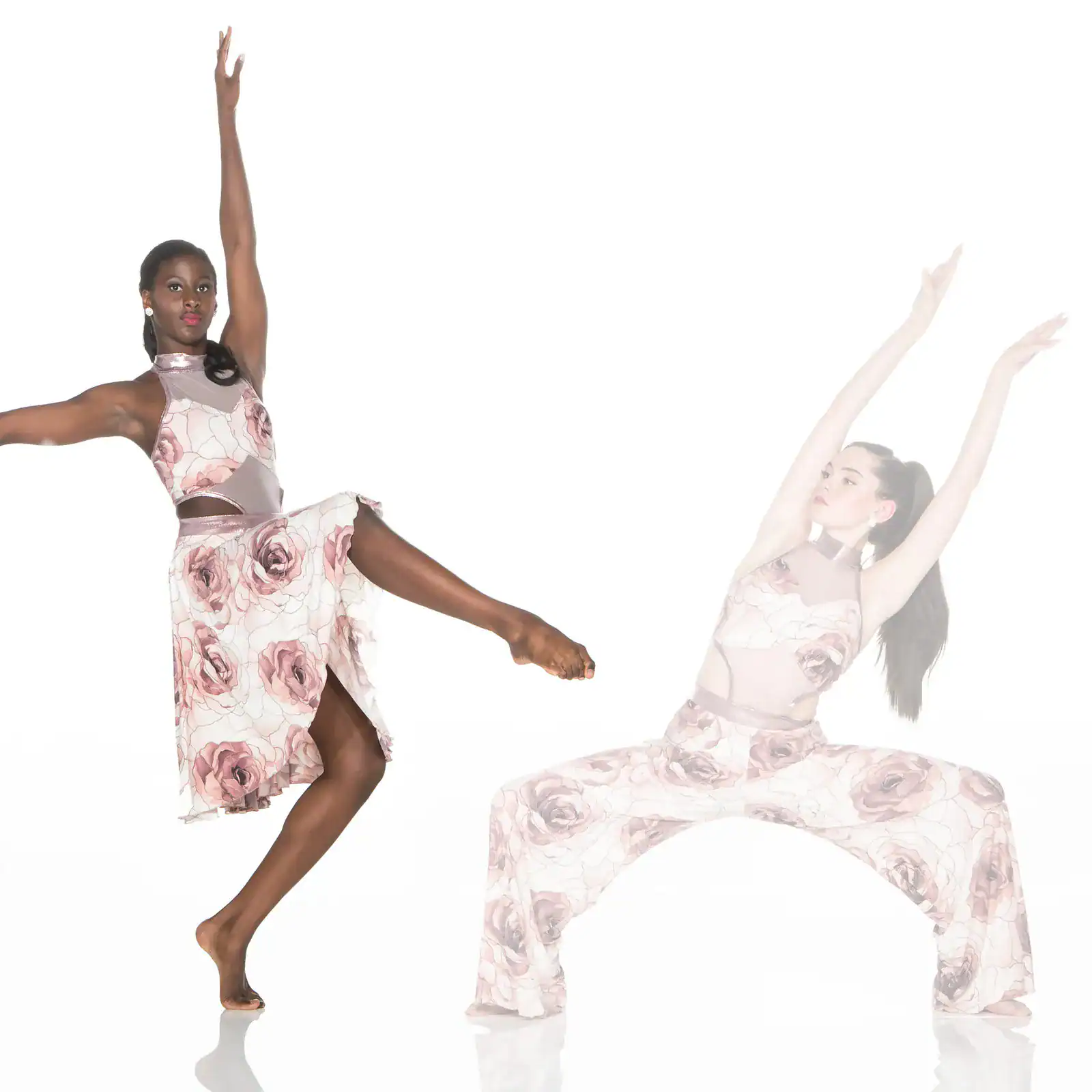 Two dancers pose in matching floral costumes against white background.