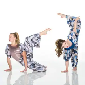 Two dancers in patterned costumes performing acrobatic poses
