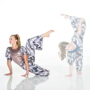 Two women in patterned outfits performing acrobatic poses