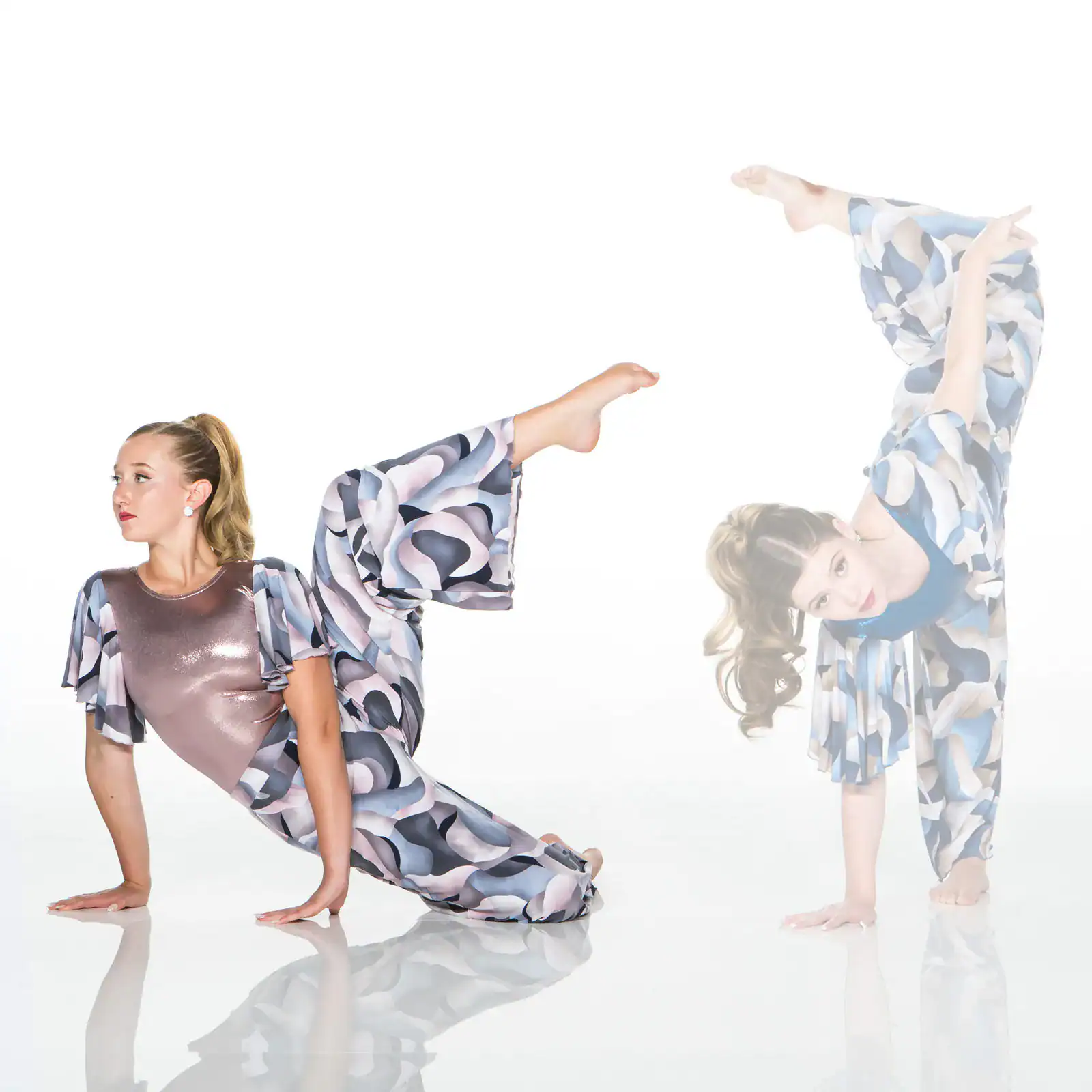 Two women in patterned outfits performing acrobatic poses