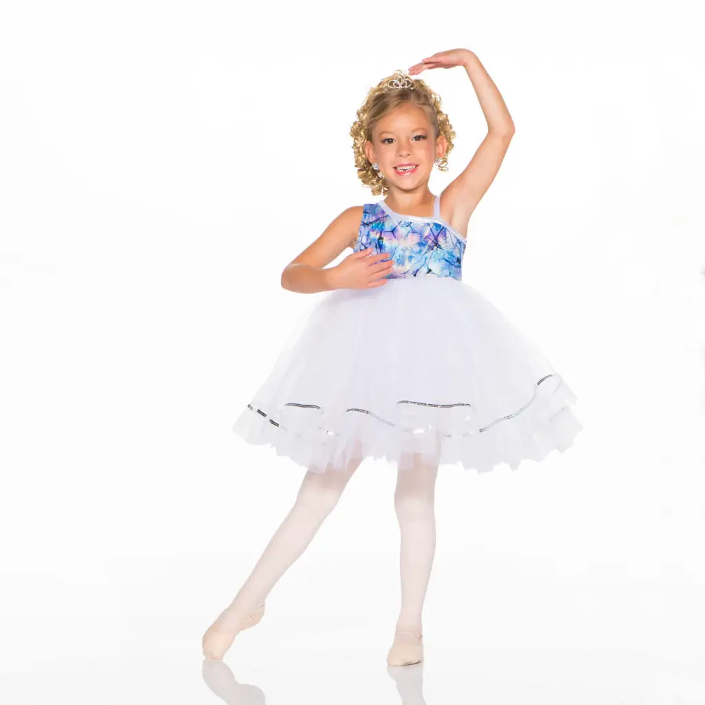 Young ballerina in blue and white tutu posing