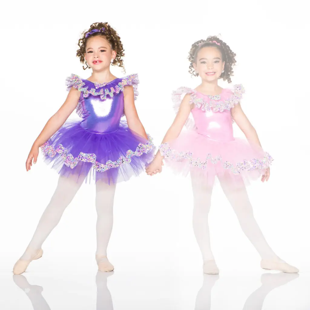Two young ballerinas in purple and pink tutus